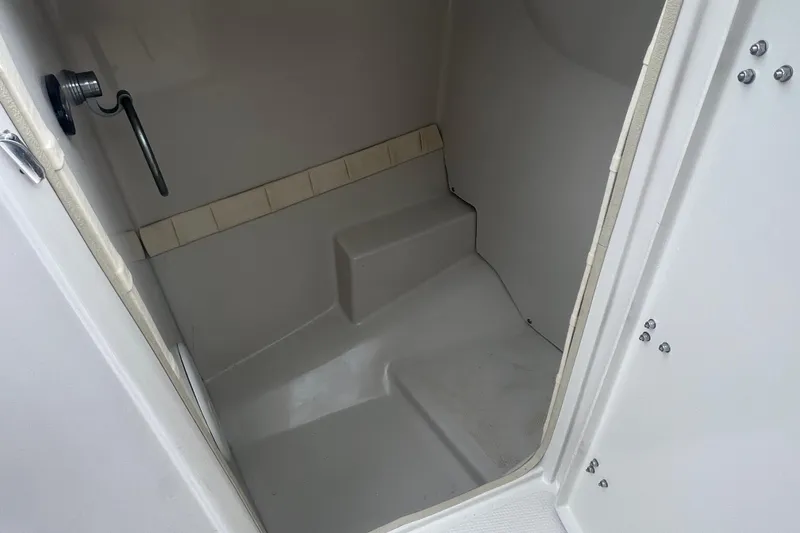 Slide: The Image of 2005 Tahoe 234 boat interior cabin with seating and handle. - 15