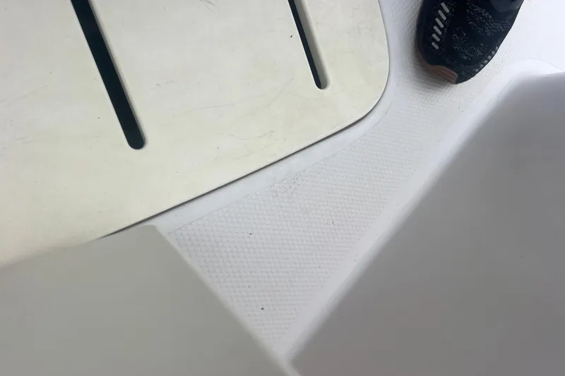 Slide: The Image of White textured surface with a shoe, part of a 2005 Tahoe 234 boat. - 17