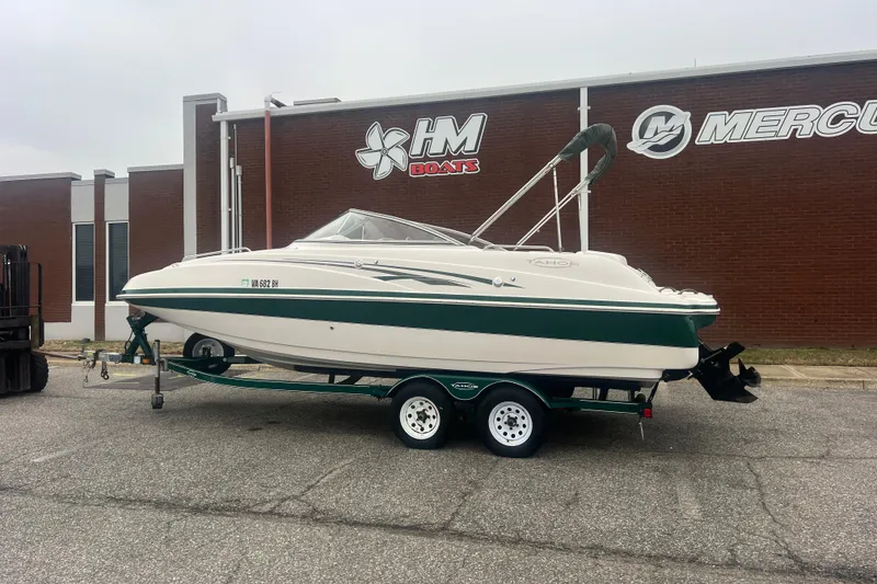Slide: The Image of 2005 Tahoe 234 boat on trailer outside HM Boats building. - 2