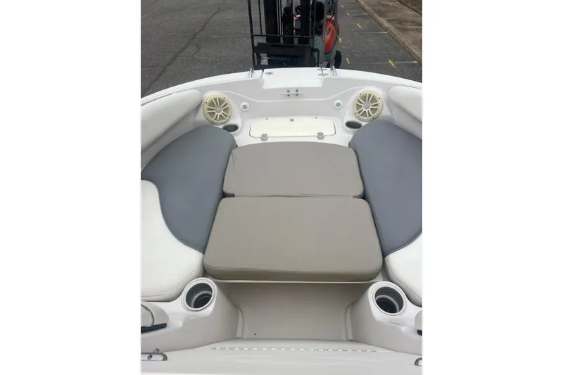 Slide: The Image of 2005 Tahoe 234 boat interior with cushioned seating and cup holders. - 21