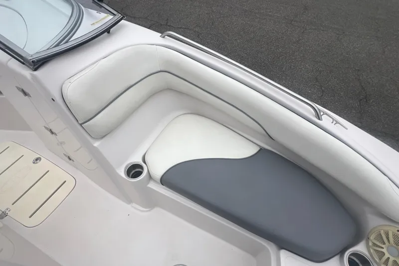 Slide: The Image of 2005 Tahoe 234 boat interior with white and gray cushioned seating. - 24