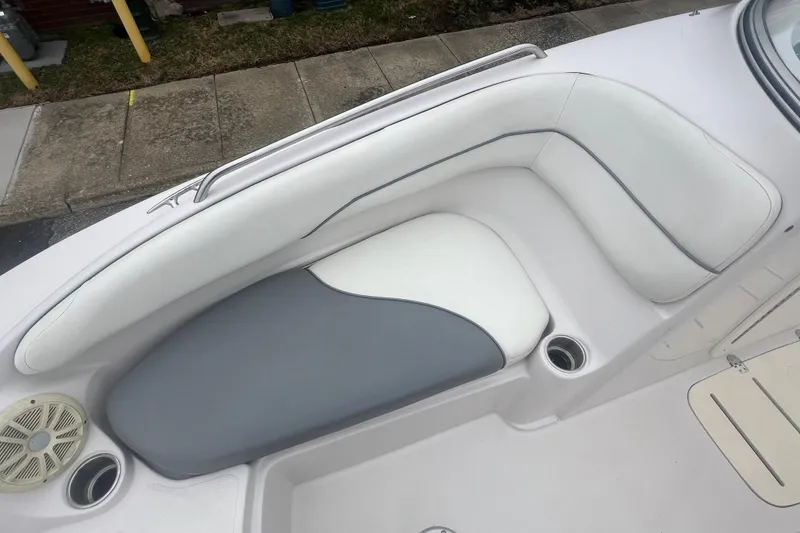 Slide: The Image of 2005 Tahoe 234 boat interior with white and gray seating, cup holders, and speaker. - 25