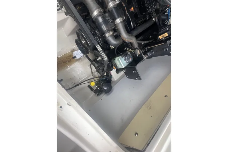 Slide: The Image of Engine compartment of a 2005 Tahoe 234 boat, showing mechanical components and hoses. - 32