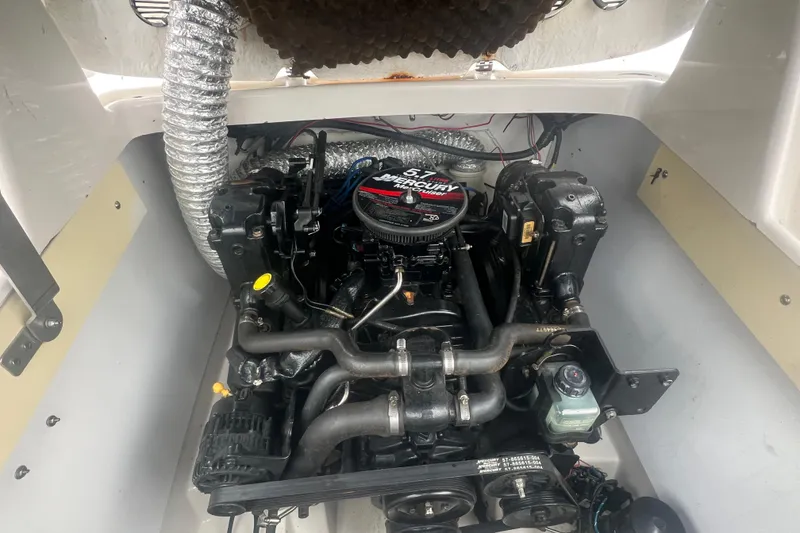 Slide: The Image of Engine compartment of a 2005 Tahoe 234 boat with a 5.7L Mercury engine. - 33