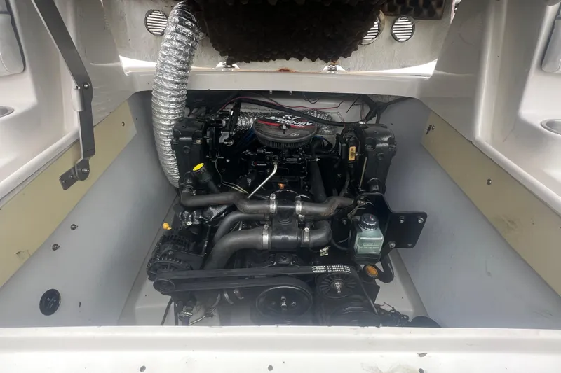 Slide: The Image of Engine compartment of a 2005 Tahoe 234 boat, showcasing detailed mechanical components. - 36