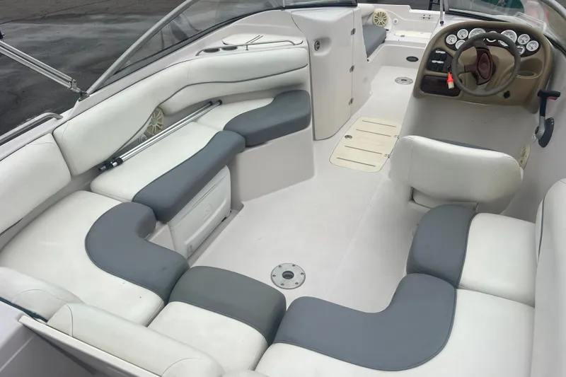 Slide: The Image of Interior of a 2005 Tahoe 234 boat with white and gray seating. - 37