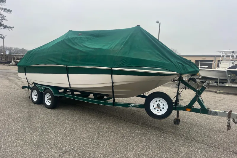 Slide: The Image of Covered 2005 Tahoe 234 boat on trailer in parking lot. - 39