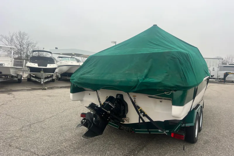 Slide: The Image of Covered 2005 Tahoe 234 boat on trailer in parking lot. - 42