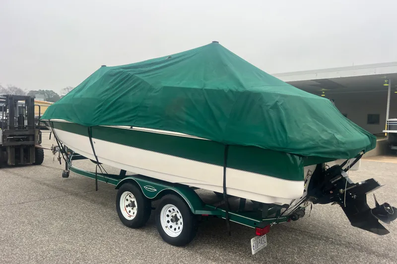 Slide: The Image of Covered 2005 Tahoe 234 boat on trailer, parked outdoors. - 43