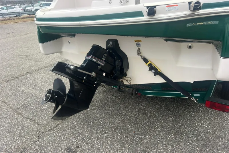 Slide: The Image of 2005 Tahoe 234 boat with MerCruiser outboard motor on a trailer. - 6