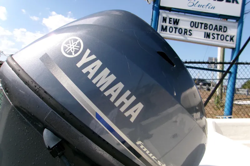 Slide: The Image of Yamaha outboard motor on 2012 Carolina Skiff JVX16CC, with dealership sign in background. - 10