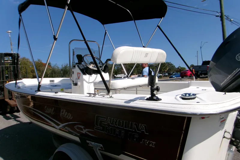 Slide: The Image of 2012 Carolina Skiff JVX16CC boat with canopy, parked on trailer, side view. - 12