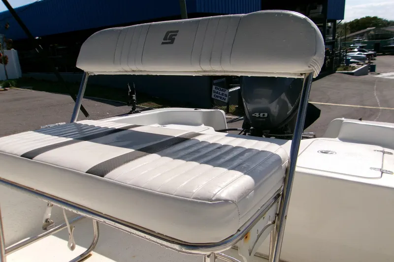 Slide: The Image of 2012 Carolina Skiff JVX16CC boat seat with striped upholstery and outboard motor. - 3