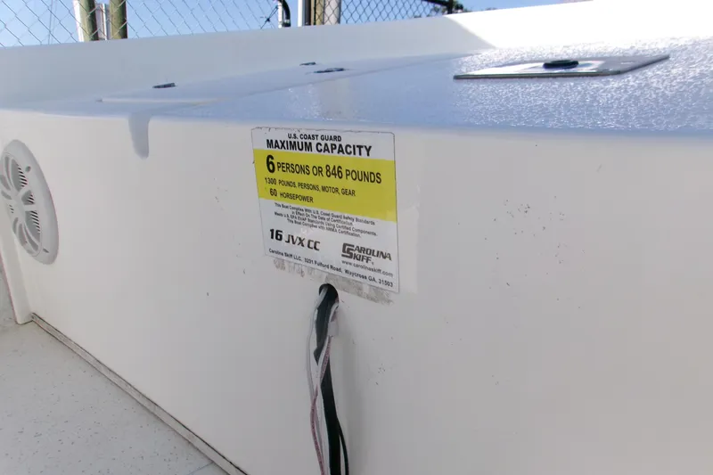 Slide: The Image of 2012 Carolina Skiff JVX16CC boat capacity label, 6 persons or 846 pounds. - 6