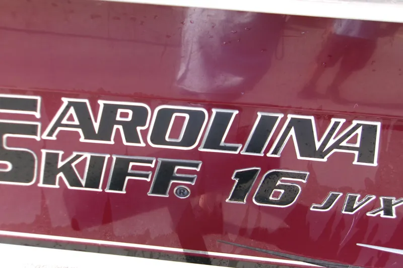 Slide: The Image of Close-up of 2012 Carolina Skiff JVX16CC logo on maroon background. - 7