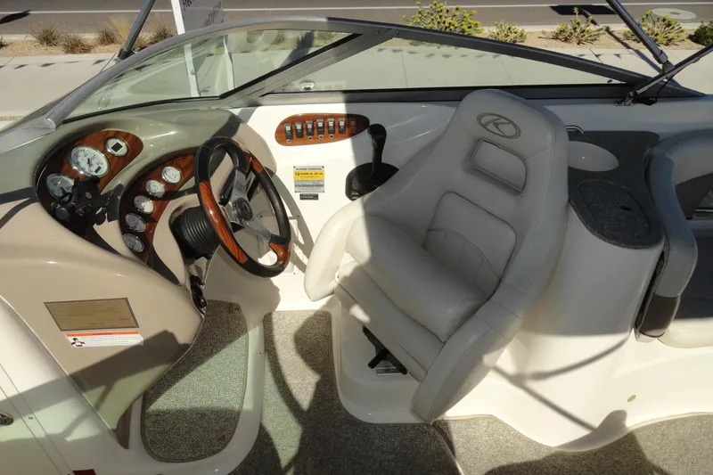 Slide: The Image of 2005 Kayot S245 boat interior with steering wheel, gauges, and captain's chair. - 13