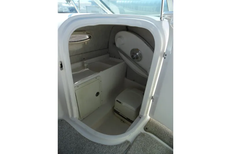Slide: The Image of 2005 Kayot S245 boat interior with compact bathroom and storage area. - 16