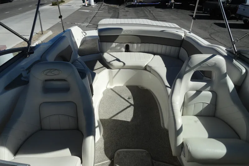 Slide: The Image of 2005 Kayot S245 boat interior with white seating and carpeted floor. - 20