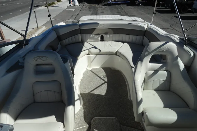 Slide: The Image of 2005 Kayot S245 boat interior with white cushioned seating and open deck layout. - 21
