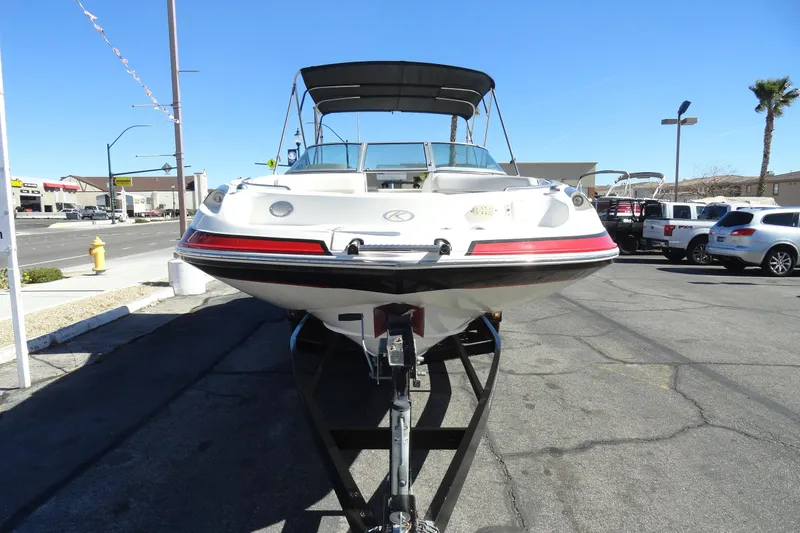 Slide: The Image of 2005 Kayot S245 boat on trailer in parking lot, sunny day, clear sky. - 3