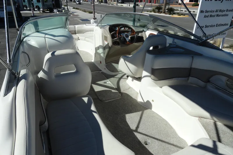 Slide: The Image of 2005 Kayot S245 boat interior with white seating and steering wheel. - 7
