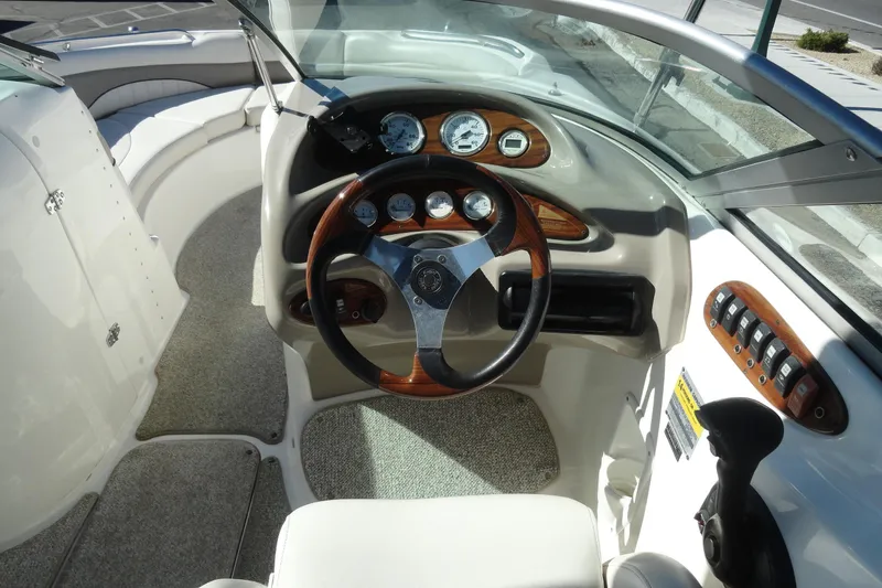 Slide: The Image of 2005 Kayot S245 boat dashboard with steering wheel and control panel. - 9