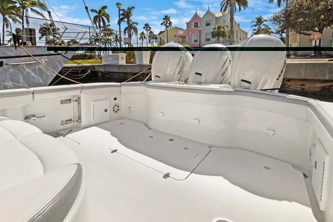 Slide: The Image of 2020 Yellowfin 39 Center Console boat with triple engines docked in a tropical marina. - 22