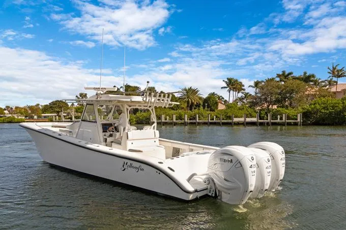 Slide: The Image of 2020 Yellowfin 39 Center Console boat with triple outboard engines on a sunny day. - 36