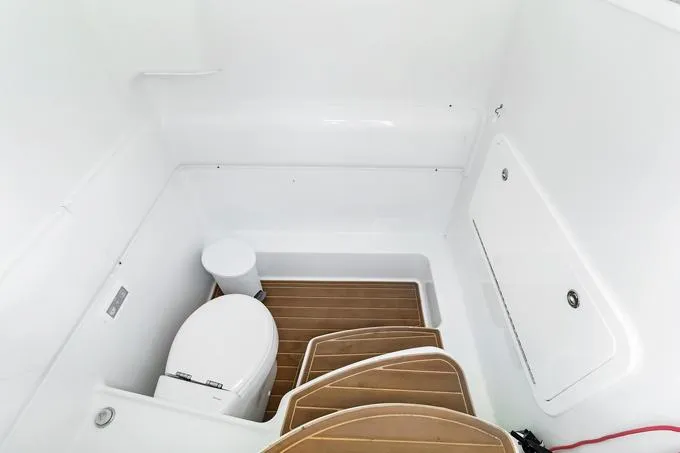 Slide: The Image of 2020 Yellowfin 39 Center Console boat interior with toilet and wooden flooring. - 8