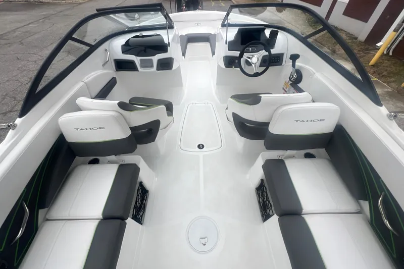 Slide: The Image of 2024 Tahoe 210 S boat interior with sleek white and gray seating, modern dashboard. - 17