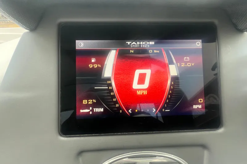 Slide: The Image of 2024 Tahoe 210 S boat dashboard display showing speed, fuel, and trim levels. - 19