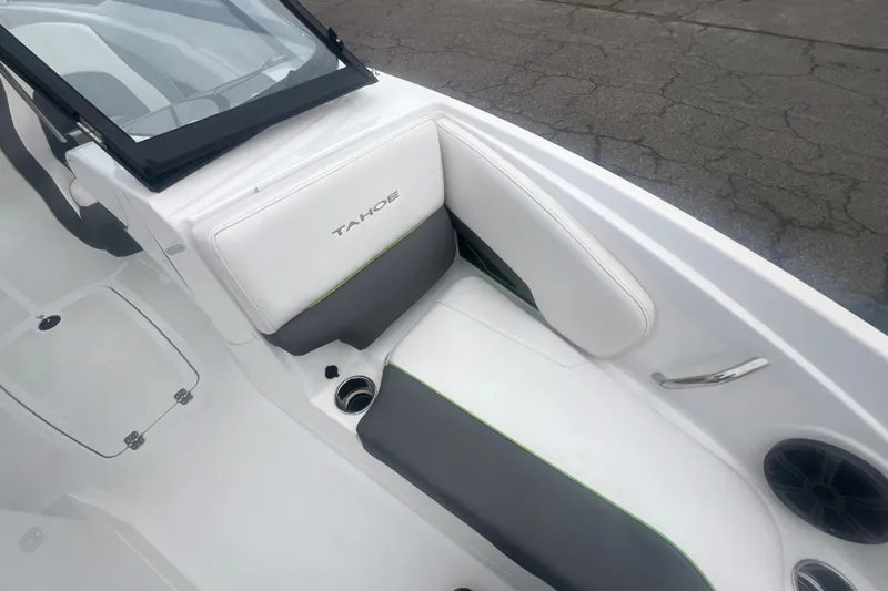 Slide: The Image of 2024 Tahoe 210 S boat interior with white and gray seating, cup holder, and speaker. - 22