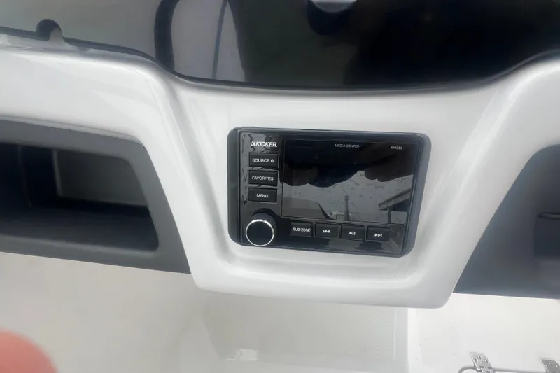 Slide: The Image of 2024 Tahoe 210 S boat dashboard with Kicker media center controls. - 25