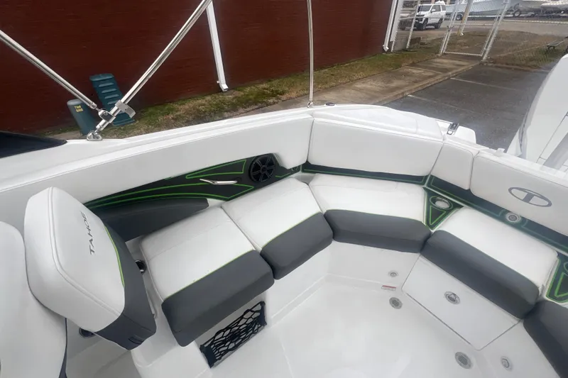 Slide: The Image of 2024 Tahoe 210 S boat interior with white and gray seating, green accents. - 28