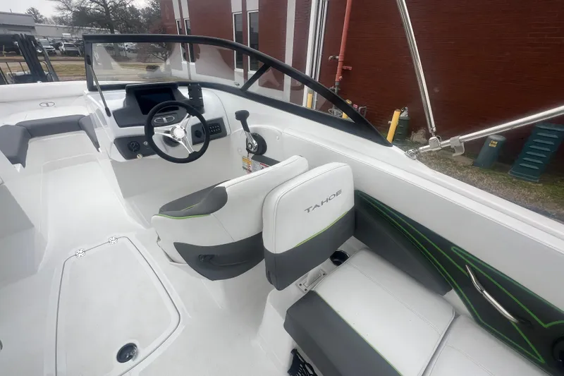 Slide: The Image of 2024 Tahoe 210 S boat interior with modern steering and seating design. - 29