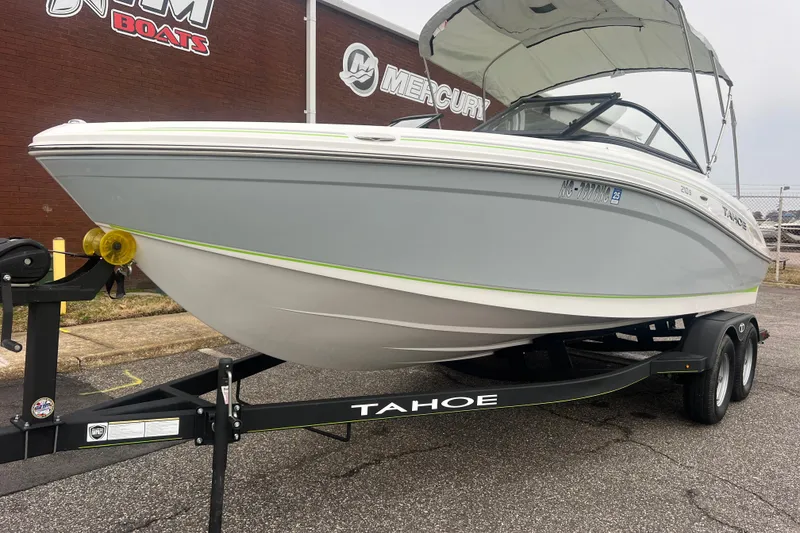 Slide: The Image of 2024 Tahoe 210 S boat on trailer, parked outside dealership. - 3