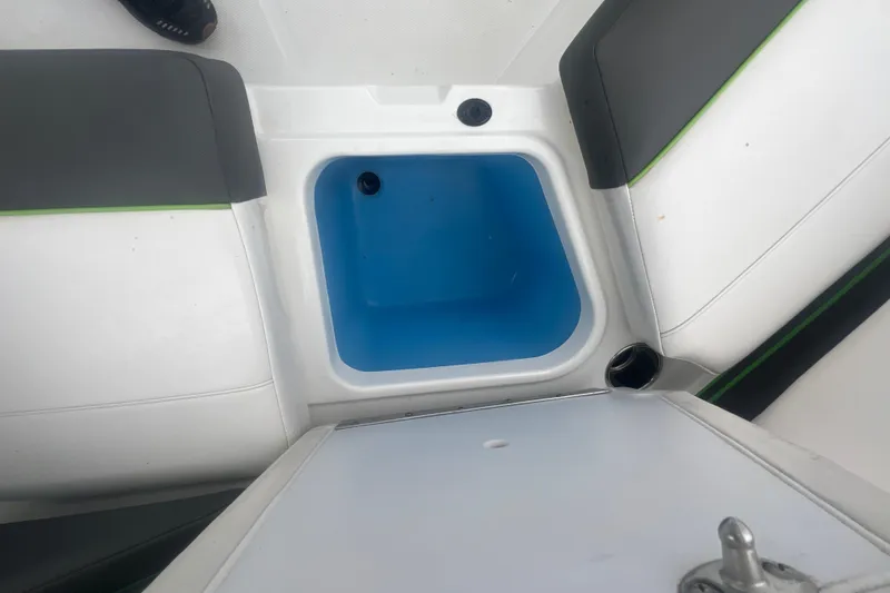 Slide: The Image of 2024 Tahoe 210 S boat interior with blue storage compartment and seating. - 33
