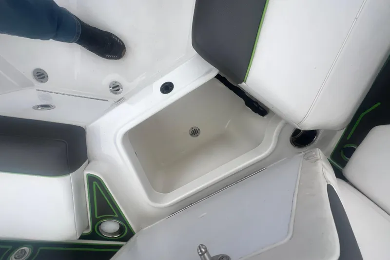 Slide: The Image of 2024 Tahoe 210 S boat interior with storage compartment and seating. - 35