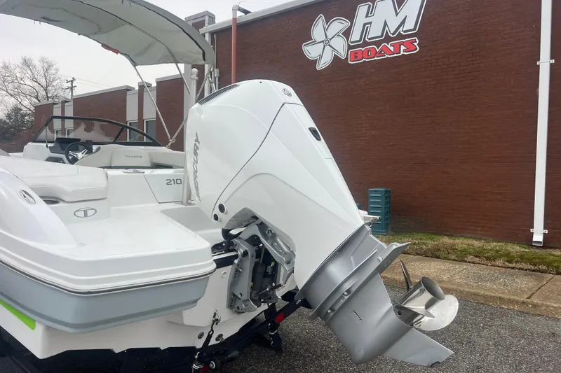 Slide: The Image of 2024 Tahoe 210 S boat with Mercury outboard motor at HM Boats dealership. - 6