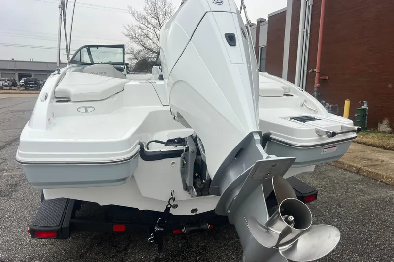 Slide: The Image of 2024 Tahoe 210 S boat rear view with outboard motor in urban setting. - 7