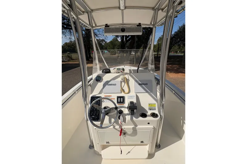 Slide: The Image of 2021 Cobia 237 Center Console boat interior with steering wheel and controls. - 12