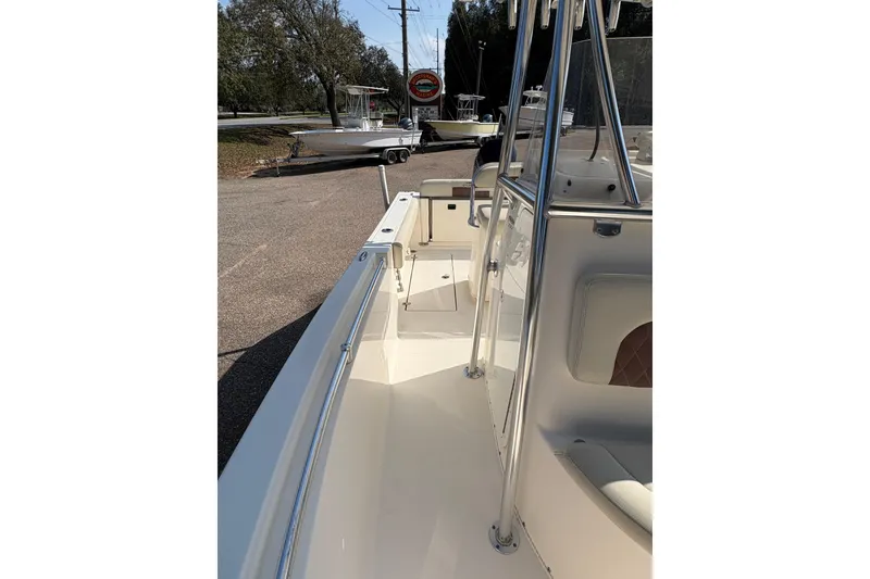 Slide: The Image of 2021 Cobia 237 Center Console boat, sleek design, parked outdoors. - 13