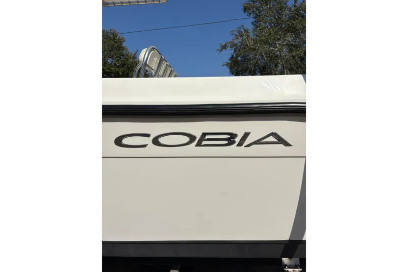 Slide: The Image of 2021 Cobia 237 Center Console boat with logo, against a clear blue sky. - 18
