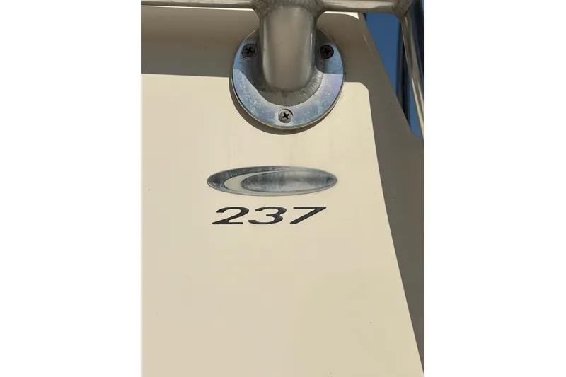 Slide: The Image of 2021 Cobia 237 Center Console boat detail with metal fixture and model number. - 19