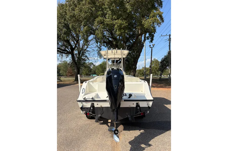 Slide: The Image of 2021 Cobia 237 Center Console boat with outboard motor, parked on a sunny day. - 6