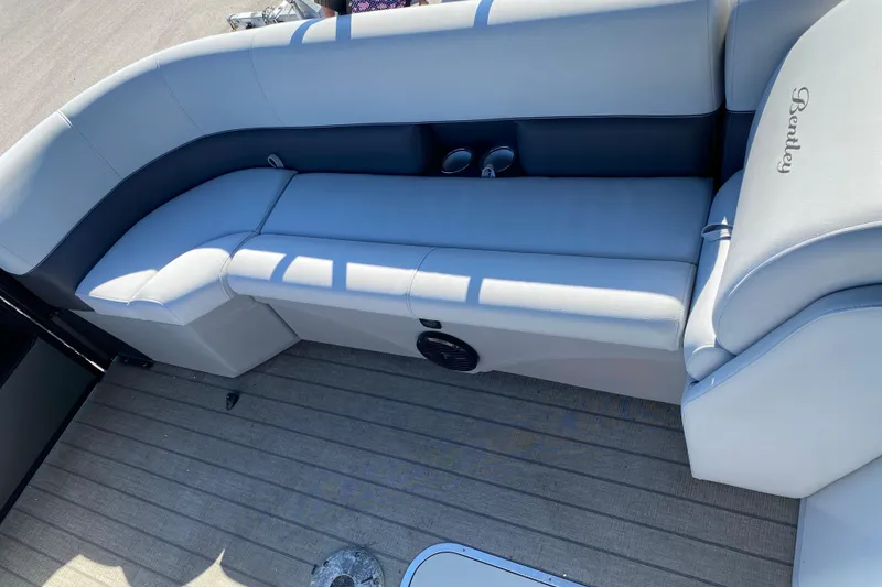 Slide: The Image of 2024 Bentley Pontoons Legacy Swingback interior seating with cup holders and elegant design. - 14