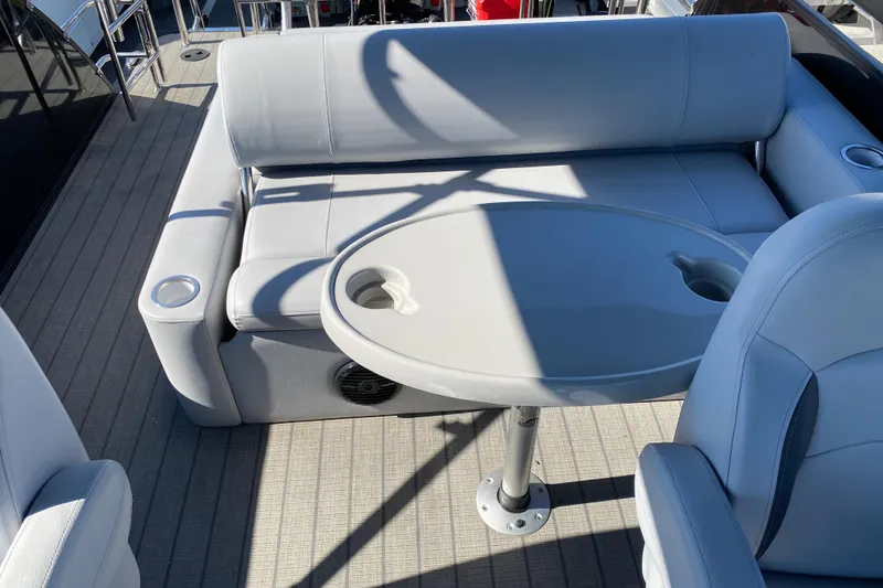 Slide: The Image of 2024 Bentley Pontoons Legacy Swingback interior with seating and table on deck. - 15