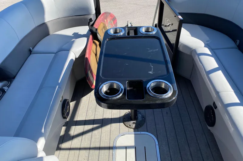 Slide: The Image of 2024 Bentley Pontoons Legacy Swingback interior with seating and table. - 16