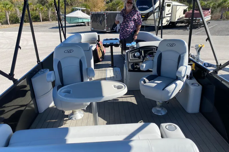 Slide: The Image of 2024 Bentley Pontoons Legacy Swingback interior with luxurious seating and modern design. - 17