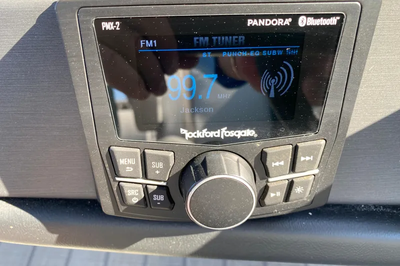 Slide: The Image of 2024 Bentley Pontoons Legacy Swingback stereo system displaying FM radio station 99.7 MHz. - 21